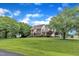 Brick home with dormers and mature trees, set on a spacious lawn with an inviting curb appeal at 4620 Gomar Ln, Fuquay Varina, NC 27526