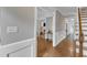 Hallway featuring hardwood floors and wall trimwork detail, open to living areas at 4620 Gomar Ln, Fuquay Varina, NC 27526