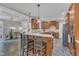 Open kitchen featuring breakfast bar, seamless flow to living space, and modern appliances at 4620 Gomar Ln, Fuquay Varina, NC 27526