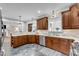 Well-lit kitchen with dark cabinets, stainless steel appliances, and plenty of countertop space at 4620 Gomar Ln, Fuquay Varina, NC 27526