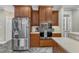 Stainless steel refrigerator with wooden cabinets, microwave, and stainless oven appliances at 4620 Gomar Ln, Fuquay Varina, NC 27526