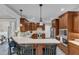 Bright kitchen boasts wooden cabinets, stainless steel appliances, and an extended countertop seating area at 4620 Gomar Ln, Fuquay Varina, NC 27526