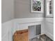 Bright laundry room with white wainscoting and a glimpse of the outdoors through the window at 4620 Gomar Ln, Fuquay Varina, NC 27526