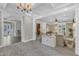 Open-concept living space featuring elegant trim, columns, and seamless flow between living areas at 4620 Gomar Ln, Fuquay Varina, NC 27526