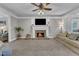Cozy living room with fireplace, stone hearth, neutral tones, and comfortable seating at 4620 Gomar Ln, Fuquay Varina, NC 27526