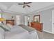 Bright main bedroom featuring a tray ceiling, carpet flooring and wooden dresser at 4620 Gomar Ln, Fuquay Varina, NC 27526
