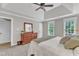 Bedroom with a tray ceiling, carpet flooring and a large wooden dresser with mirror at 4620 Gomar Ln, Fuquay Varina, NC 27526