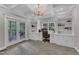 Bright office with built-in shelves and cabinets, a large window, and French doors to the outside at 4620 Gomar Ln, Fuquay Varina, NC 27526