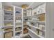 Walk-in pantry with multiple shelves and baskets for storing kitchen and household goods at 4620 Gomar Ln, Fuquay Varina, NC 27526