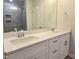 Modern bathroom with double sinks, white cabinetry, and a glass-enclosed tiled shower at 5028 Jowetts Walk Dr # 24, Cary, NC 27519