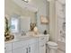 Bathroom with white vanity, framed mirror, tub shower, and neutral paint at 5028 Jowetts Walk Dr # 24, Cary, NC 27519