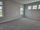 Spacious bedroom with plush carpet and multiple windows providing natural light and views at 5028 Jowetts Walk Dr # 24, Cary, NC 27519