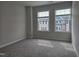 Spacious bedroom with plush carpet and two large windows providing natural light at 5028 Jowetts Walk Dr # 24, Cary, NC 27519