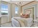 Stylish bedroom with large windows, modern lighting, and a unique decorative headboard design at 5028 Jowetts Walk Dr # 24, Cary, NC 27519