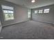 Large bedroom with plush carpet and multiple windows providing natural light and views at 5028 Jowetts Walk Dr # 24, Cary, NC 27519
