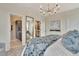 Beautiful bedroom features a statement chandelier, decorative pillows, and an ensuite bath at 5028 Jowetts Walk Dr # 24, Cary, NC 27519