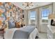 Bright bedroom with patterned wall, natural light from windows, and modern light fixture at 5028 Jowetts Walk Dr # 24, Cary, NC 27519