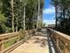 Wooden walking bridge with safety railings surrounded by trees in a nature area at 5028 Jowetts Walk Dr # 24, Cary, NC 27519