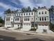 Exterior facade of new townhomes with stone accents, painted in neutral and pastel colors at 5028 Jowetts Walk Dr # 24, Cary, NC 27519