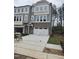 Charming townhouse featuring a garage, multiple windows, and neutral-colored siding with brick accents at 5028 Jowetts Walk Dr # 24, Cary, NC 27519