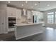 Modern kitchen boasts stainless appliances, island with pendant lighting, and sleek white cabinetry at 5028 Jowetts Walk Dr # 24, Cary, NC 27519