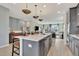 Open-concept kitchen showcasing a large island with seating, stainless steel appliances, and seamless flow to the living area at 5028 Jowetts Walk Dr # 24, Cary, NC 27519