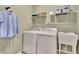 Well-equipped laundry room featuring a washer, dryer, utility sink, and overhead shelving at 5028 Jowetts Walk Dr # 24, Cary, NC 27519
