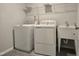 Laundry room featuring a washing machine, dryer, utility sink, and wire shelving at 5028 Jowetts Walk Dr # 24, Cary, NC 27519