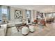 Bright living room with a modern couch, colorful artwork, natural light, and seamless transition to the kitchen area at 5028 Jowetts Walk Dr # 24, Cary, NC 27519