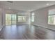 Bright and airy living room with sliding glass doors and hardwood floors at 5028 Jowetts Walk Dr # 24, Cary, NC 27519