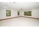Large open bedroom with natural light from three big windows, a ceiling fan, and neutral carpet at 5800 Heatherbrook Cir, Raleigh, NC 27612