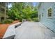 The home's deck features bench seating, a wooden floor, and overlooks the yard at 5800 Heatherbrook Cir, Raleigh, NC 27612