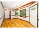 Bright dining area with hardwood floors, natural light from surrounding windows, and multiple entryways at 5800 Heatherbrook Cir, Raleigh, NC 27612