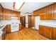 Bright kitchen features a white countertop, wood cabinets, and hardwood floors extending into the dining area at 5800 Heatherbrook Cir, Raleigh, NC 27612