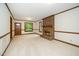 Spacious living room with a brick fireplace, large windows, and neutral carpet at 5800 Heatherbrook Cir, Raleigh, NC 27612