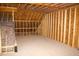 Unfinished attic showing the exposed beams and insulation, ready for customization at 5900 Tranquil Cv, Youngsville, NC 27596