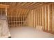 Attic space featuring exposed framing, insulation, and wooden beams, showing potential for customization at 5900 Tranquil Cv, Youngsville, NC 27596