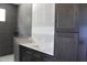 Stylish bathroom with a white countertop, gray cabinets, and tiled walls at 5900 Tranquil Cv, Youngsville, NC 27596