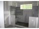 Bathroom under construction, featuring cement walls and a small window at 5900 Tranquil Cv, Youngsville, NC 27596