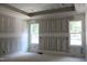 Spacious bedroom with architectural ceiling design and decorative feature wall at 5900 Tranquil Cv, Youngsville, NC 27596