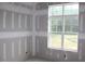Bedroom under construction. Features large windows and natural light at 5900 Tranquil Cv, Youngsville, NC 27596