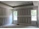 Spacious bedroom with trim work, tray ceiling and large windows offering natural light at 5900 Tranquil Cv, Youngsville, NC 27596