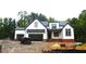 Beautiful craftsman-style home with a mix of white siding, brick and natural accents at 5900 Tranquil Cv, Youngsville, NC 27596