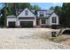 New construction showcasing the exterior elevation of a white home with an open garage at 5900 Tranquil Cv, Youngsville, NC 27596