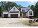 New construction showcasing the exterior elevation of a white home with an open garage at 5900 Tranquil Cv, Youngsville, NC 27596
