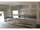 Image of a garage in the process of construction and showing a large window and material stored in the building at 5900 Tranquil Cv, Youngsville, NC 27596