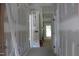 Hallway showing architectural trim work leading to a sunlit area at 5900 Tranquil Cv, Youngsville, NC 27596