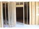Interior framing showcasing door frames with exposed studs, highlighting potential room layouts at 5900 Tranquil Cv, Youngsville, NC 27596