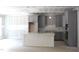 Spacious kitchen featuring grey cabinetry and center island under construction at 5900 Tranquil Cv, Youngsville, NC 27596