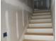 View of unfinished wooden stairs with white risers, ready for carpeting or finishing at 5900 Tranquil Cv, Youngsville, NC 27596